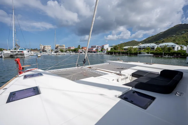 Blue Octane Yacht Photos Pics 2018 Lagoon 52 F catamaran docked in a scenic marina with lush hills.