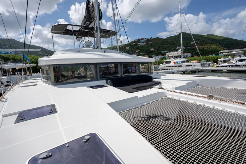 Blue Octane Yacht Photos Pics 2018 Lagoon 52 F catamaran docked, featuring spacious deck and scenic marina backdrop.