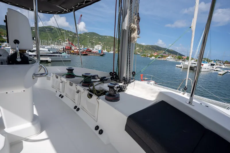 Blue Octane Yacht Photos Pics 2018 Lagoon 52 F yacht deck with marina view, featuring winches and seating.