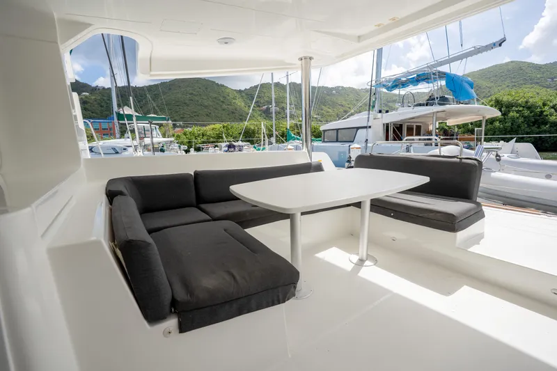 Blue Octane Yacht Photos Pics Outdoor seating area on a 2018 Lagoon 52 F catamaran, with scenic marina views.