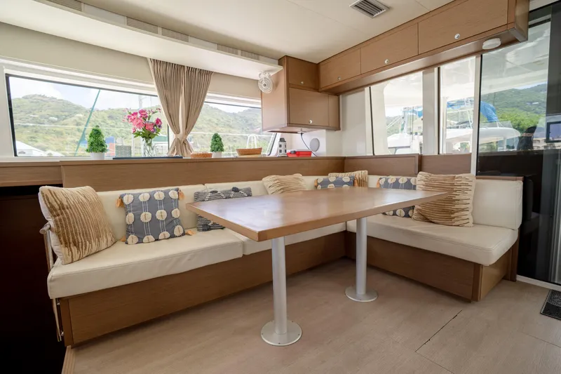 Blue Octane Yacht Photos Pics Interior of 2018 Lagoon 52 F yacht with cozy dining area and scenic window view.