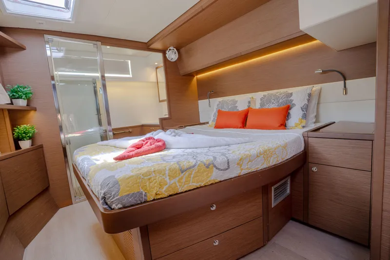 Blue Octane Yacht Photos Pics Luxurious cabin interior of 2018 Lagoon 52 F yacht with modern decor and cozy bedding.
