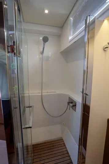 Blue Octane Yacht Photos Pics Modern shower area in 2018 Lagoon 52 F yacht with glass door and wooden floor.