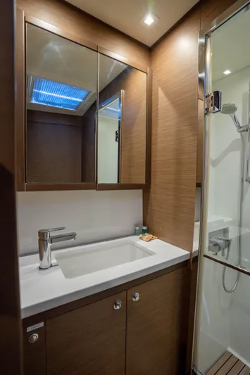 Blue Octane Yacht Photos Pics Luxurious bathroom in 2018 Lagoon 52 F yacht with modern fixtures and wood accents.