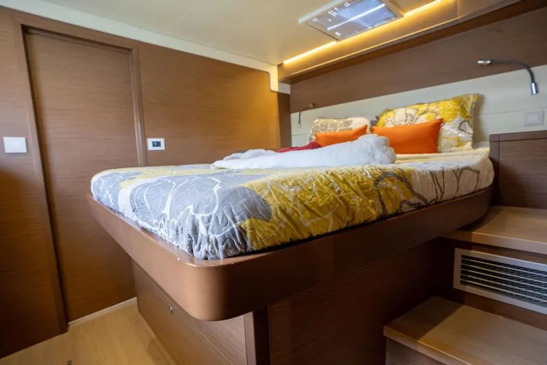 Blue Octane Yacht Photos Pics Luxurious cabin interior of 2018 Lagoon 52 F yacht with stylish bedding and wood finish.