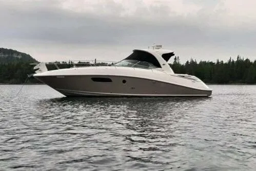  Yacht Photos Pics 2010 Sea Ray 370 Sundancer yacht on calm water with forested shoreline.