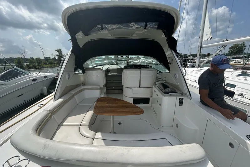  Yacht Photos Pics 2010 Sea Ray 370 Sundancer yacht interior with seating and table, docked at marina.