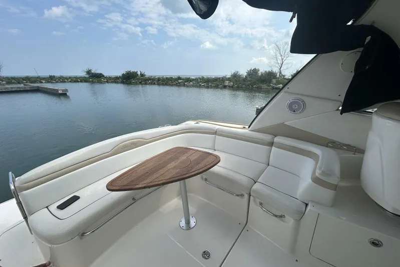  Yacht Photos Pics 2010 Sea Ray 370 Sundancer boat interior with seating and table, overlooking calm water.