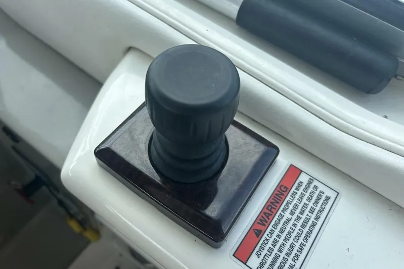  Yacht Photos Pics Joystick control on 2010 Sea Ray 370 Sundancer boat dashboard with warning label.