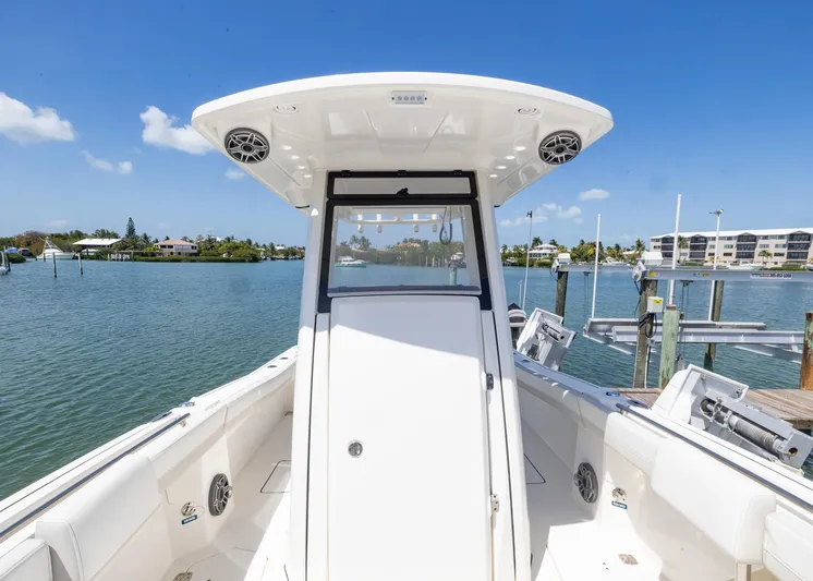  Yacht Photos Pics 2024 World Cat 260CC boat on calm water, showcasing sleek design and spacious deck.