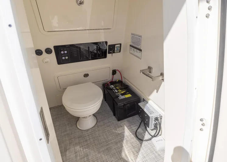  Yacht Photos Pics 2024 World Cat 260CC boat interior with toilet and battery setup.