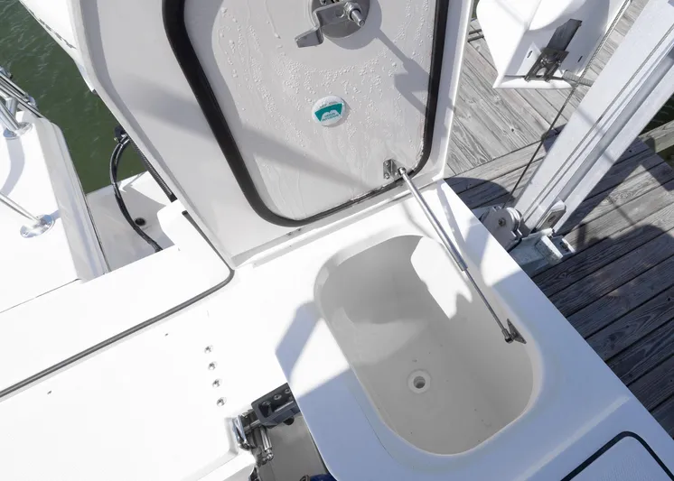  Yacht Photos Pics 2024 World Cat 260CC boat storage compartment with open hatch, dockside view.