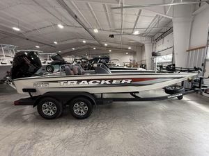 2025 Tracker Savage 215 boat in showroom, side view, on trailer.