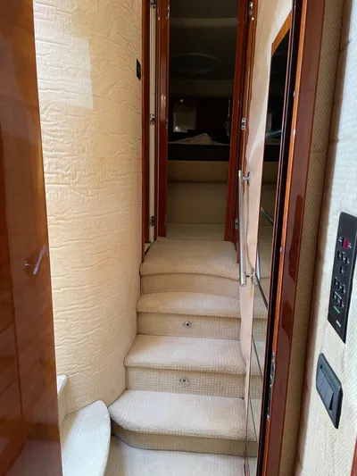 Mercia Yacht Photos Pics Interior hallway of a 2002 Azimut 55 Flybridge yacht with carpeted stairs.