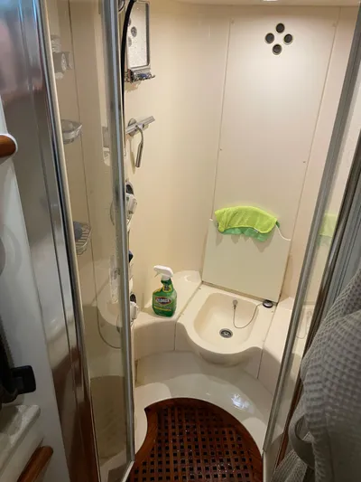 Mercia Yacht Photos Pics 2002 Azimut 55 Flybridge yacht bathroom with shower and cleaning supplies.