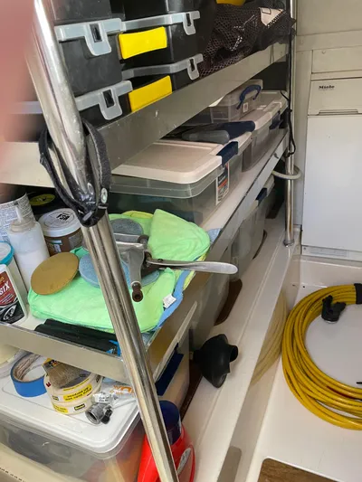 Mercia Yacht Photos Pics Storage area on a 2002 Azimut 55 Flybridge yacht with organized shelves and equipment.