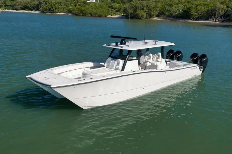 Yacht Photos Pics 2023 Freeman 43 boat on calm water, featuring sleek design and multiple outboard engines.