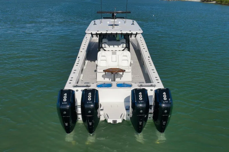  Yacht Photos Pics 2023 Freeman 43 boat with four powerful outboard engines on calm water.