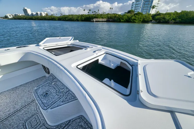  Yacht Photos Pics 2023 Freeman 43 boat deck with open storage compartments on calm water.