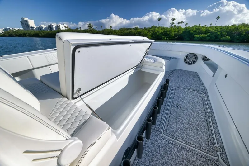  Yacht Photos Pics Luxurious 2023 Freeman 43 boat interior with seating and storage, set against a scenic waterfront.
