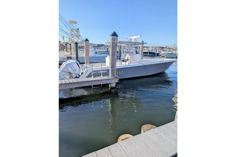  Yacht Photos Pics 2017 Contender 32 ST boat docked at marina, clear blue sky background.