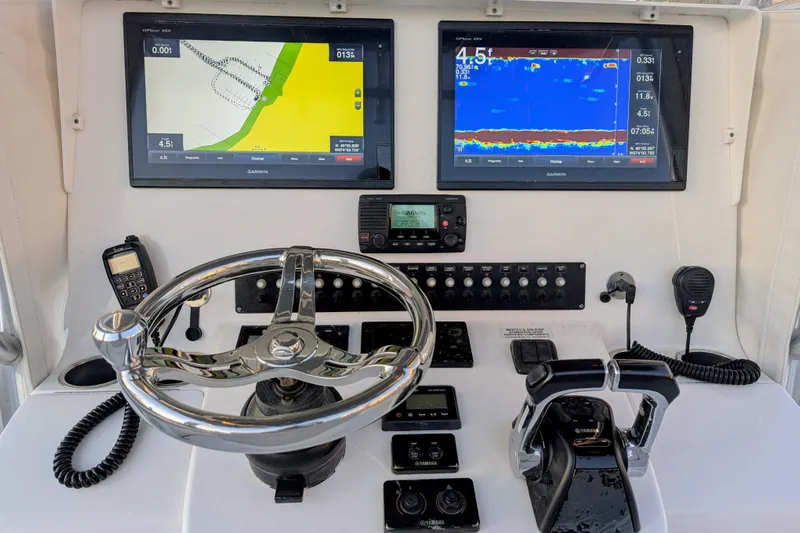  Yacht Photos Pics 2017 Contender 32 ST boat dashboard with Garmin navigation displays and controls.
