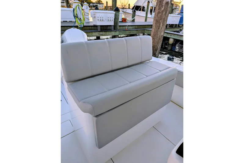  Yacht Photos Pics 2017 Contender 32 ST boat seat, docked with marina background.