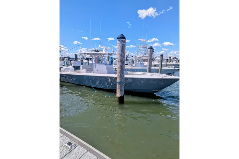  Yacht Photos Pics 2017 Contender 32 ST boat docked at marina under clear blue sky.