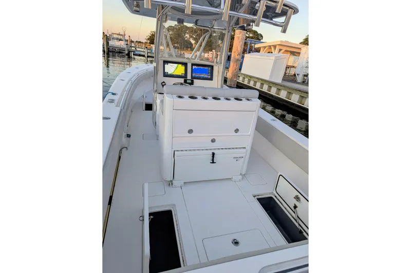  Yacht Photos Pics 2017 Contender 32 ST boat interior with navigation screens and storage compartments.