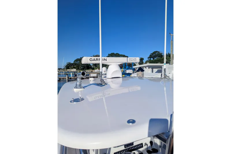  Yacht Photos Pics 2017 Contender 32 ST boat with Garmin radar, docked under clear blue sky.