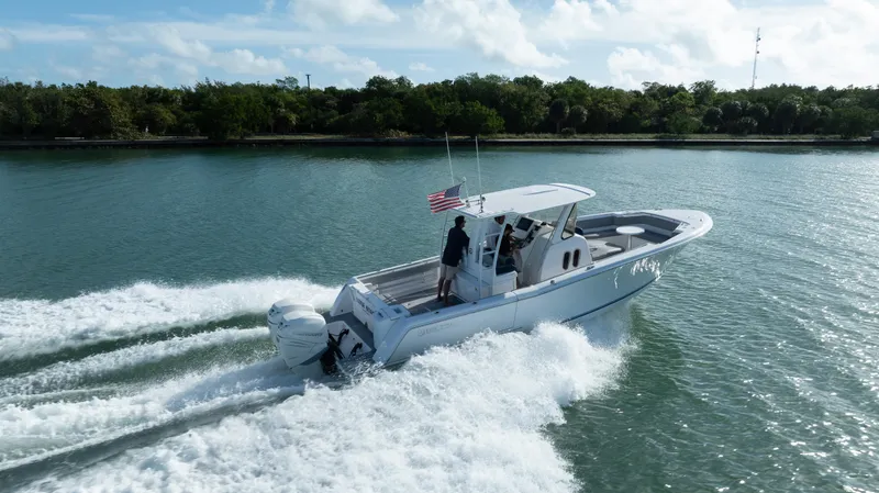  Yacht Photos Pics 2018 Belzona 325 Center Console boat cruising on a scenic waterway.