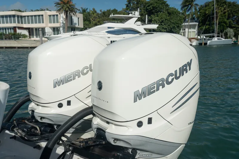  Yacht Photos Pics Twin Mercury outboard engines on a 2018 Belzona 325 Center Console boat, docked near waterfront homes.