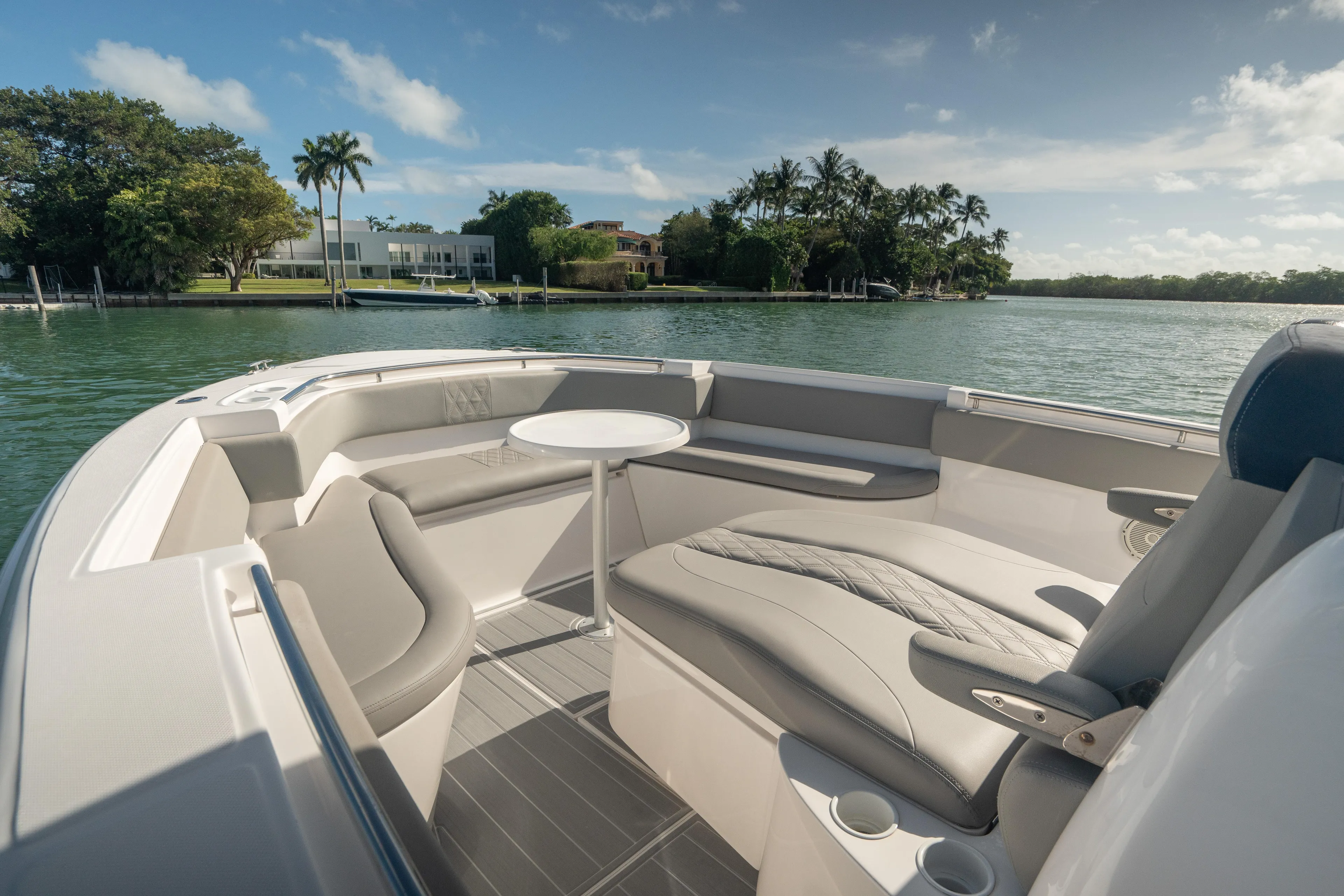  Yacht Photos Pics 2018 Belzona 325 Center Console boat interior with seating and table on calm water.