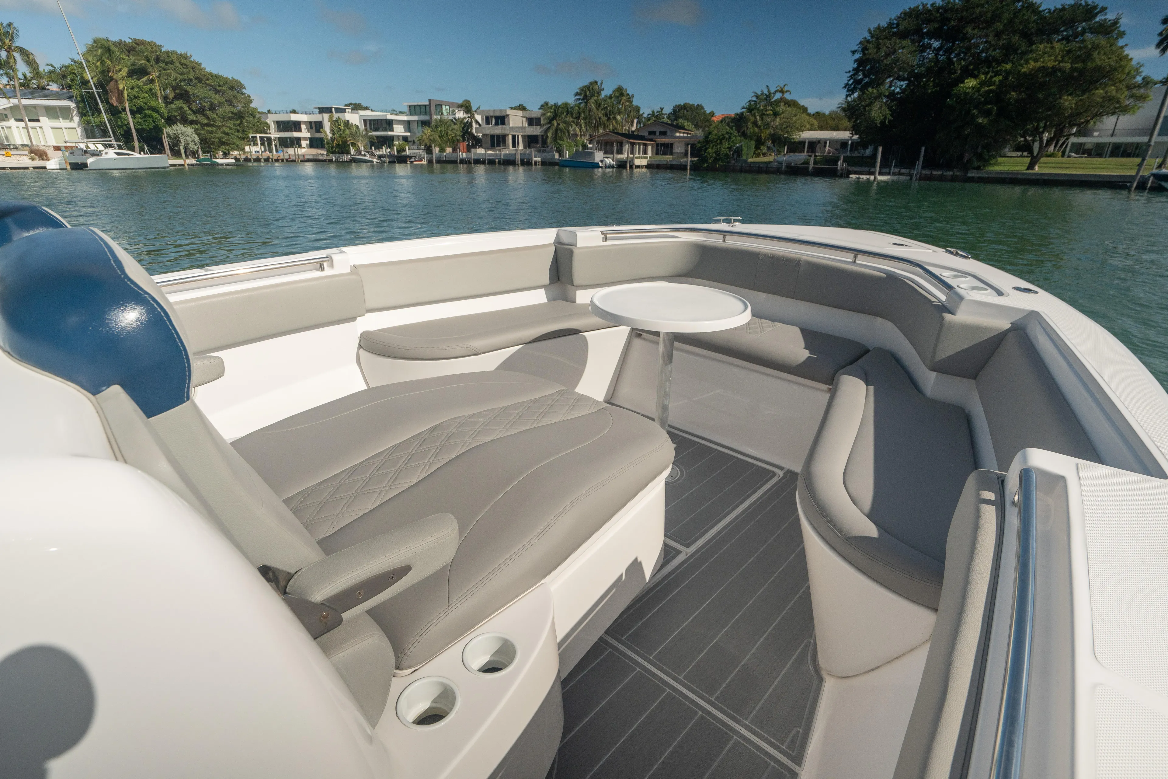  Yacht Photos Pics 2018 Belzona 325 Center Console boat interior with seating and table on calm water.