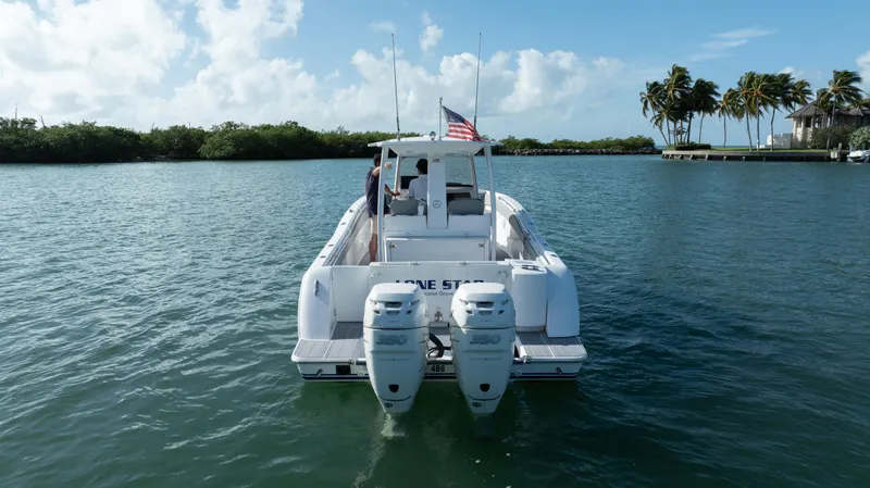  Yacht Photos Pics 2018 Belzona 325 Center Console boat on water, rear view with dual engines.