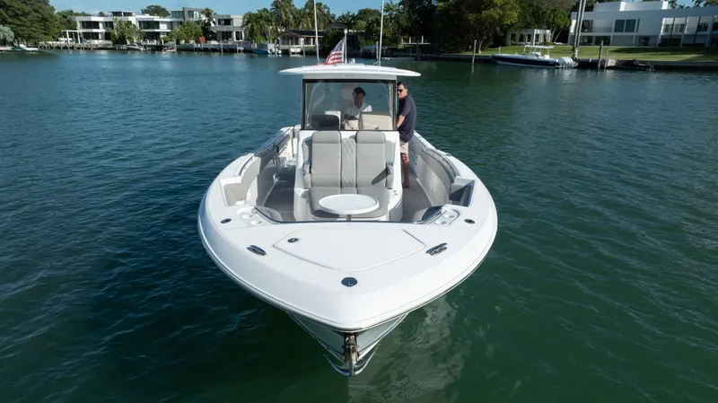  Yacht Photos Pics 2018 Belzona 325 Center Console boat on calm water, featuring spacious seating and modern design.