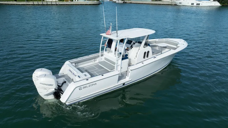  Yacht Photos Pics 2018 Belzona 325 Center Console boat on calm water, featuring twin Mercury engines.