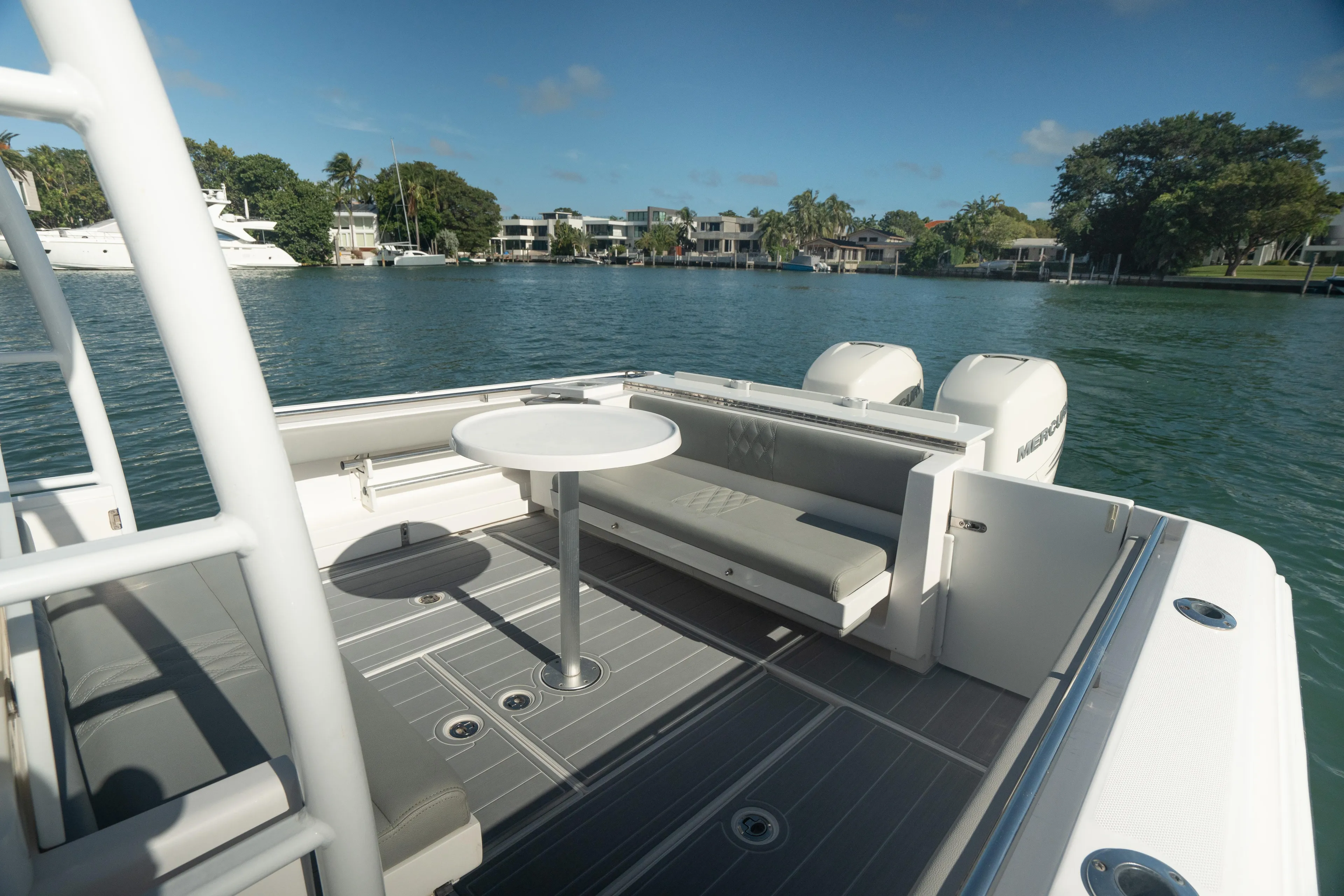  Yacht Photos Pics 2018 Belzona 325 Center Console boat with seating area and table on calm water.