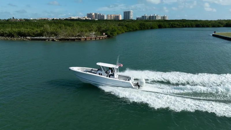  Yacht Photos Pics 2018 Belzona 325 Center Console boat cruising on a scenic waterway.