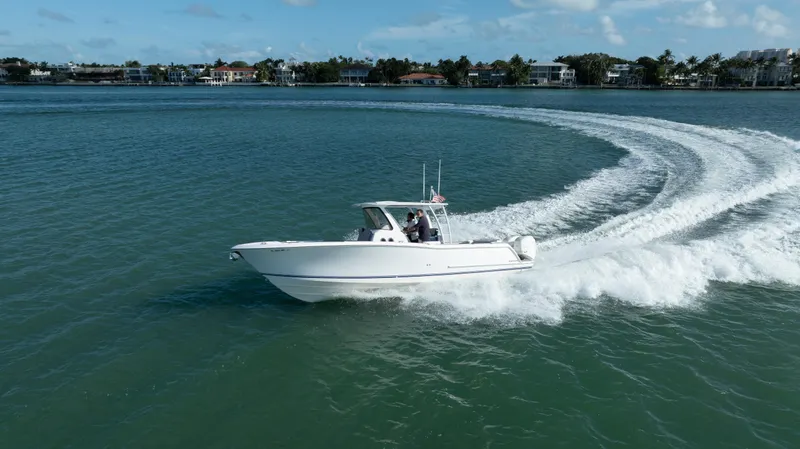  Yacht Photos Pics 2018 Belzona 325 Center Console boat cruising on a scenic waterway.
