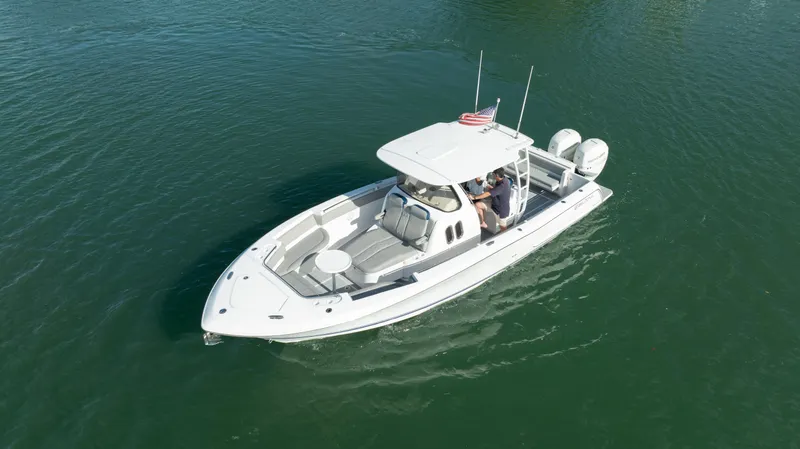  Yacht Photos Pics 2018 Belzona 325 Center Console boat cruising on clear water.