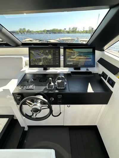 Lucy Penguin Yacht Photos Pics Cockpit of 2019 Van der Valk BeachClub 600 yacht with dual navigation screens and steering wheel.