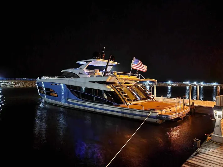 Lucy Penguin Yacht Photos Pics Luxurious 2019 Van der Valk BeachClub 600 yacht docked at night with American flag.