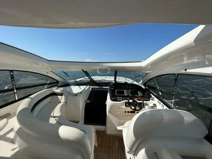  Yacht Photos Pics 2003 Sunseeker 50 Camargue yacht interior with helm and seating area.