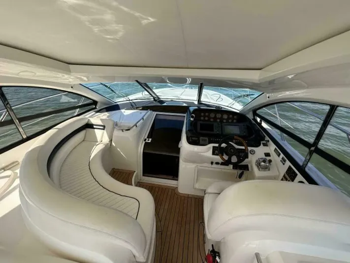  Yacht Photos Pics Interior of 2003 Sunseeker 50 Camargue yacht with white seating and modern dashboard.