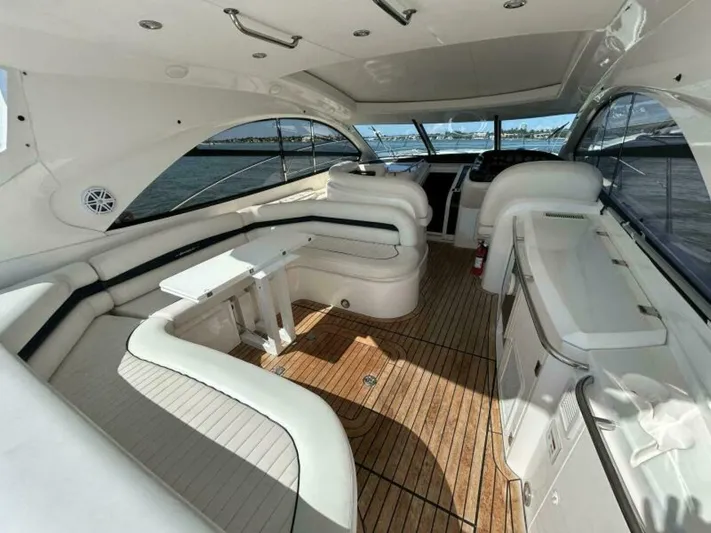  Yacht Photos Pics Luxurious interior of a 2003 Sunseeker 50 Camargue yacht with white seating and wooden flooring.