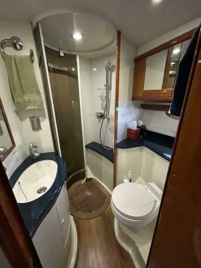  Yacht Photos Pics Compact bathroom in 2003 Sunseeker 50 Camargue yacht with shower, sink, and toilet.