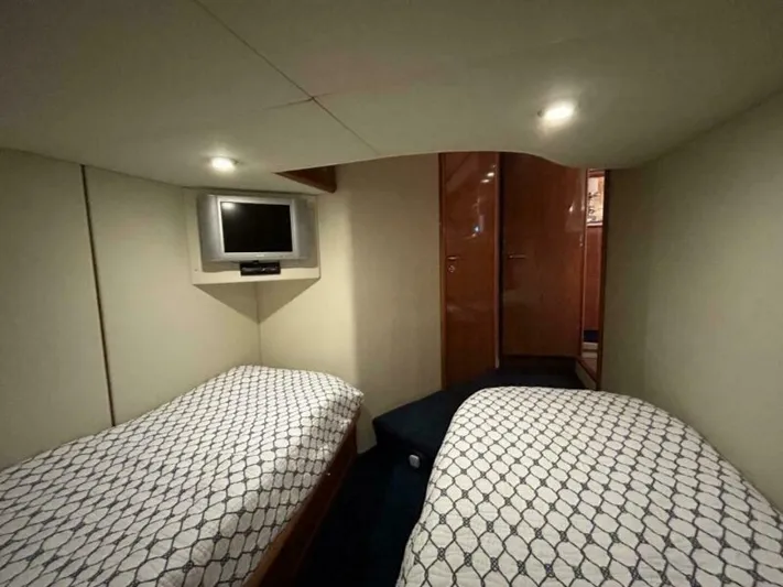  Yacht Photos Pics Twin cabin interior of 2003 Sunseeker 50 Camargue yacht with TV and modern lighting.