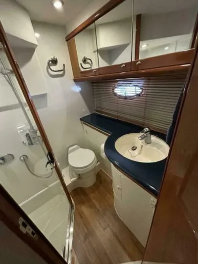 Yacht Photos Pics 2003 Sunseeker 50 Camargue yacht bathroom with shower, sink, and toilet.
