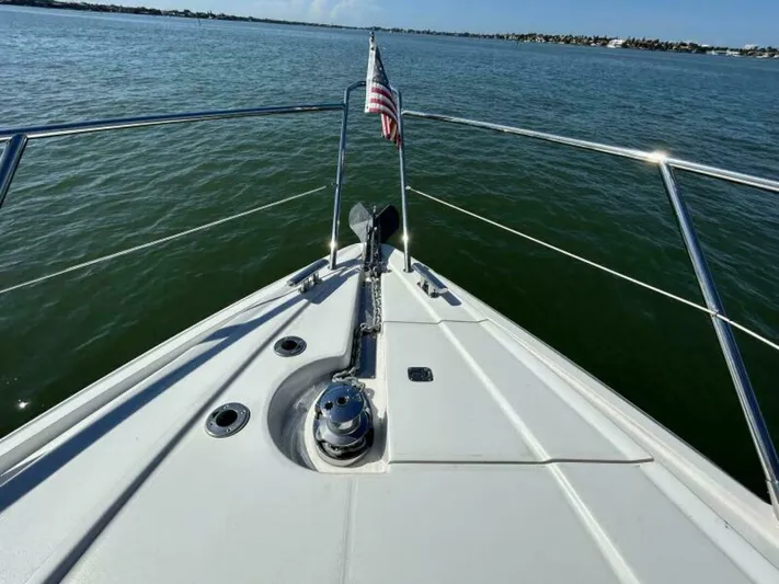  Yacht Photos Pics Bow of 2003 Sunseeker 50 Camargue yacht on calm waters with American flag.